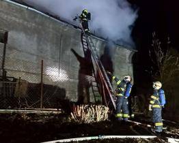 Náročný zásah hasičů u požáru hospodářské budovy: během hašení propadl strop a hrozilo zřícení